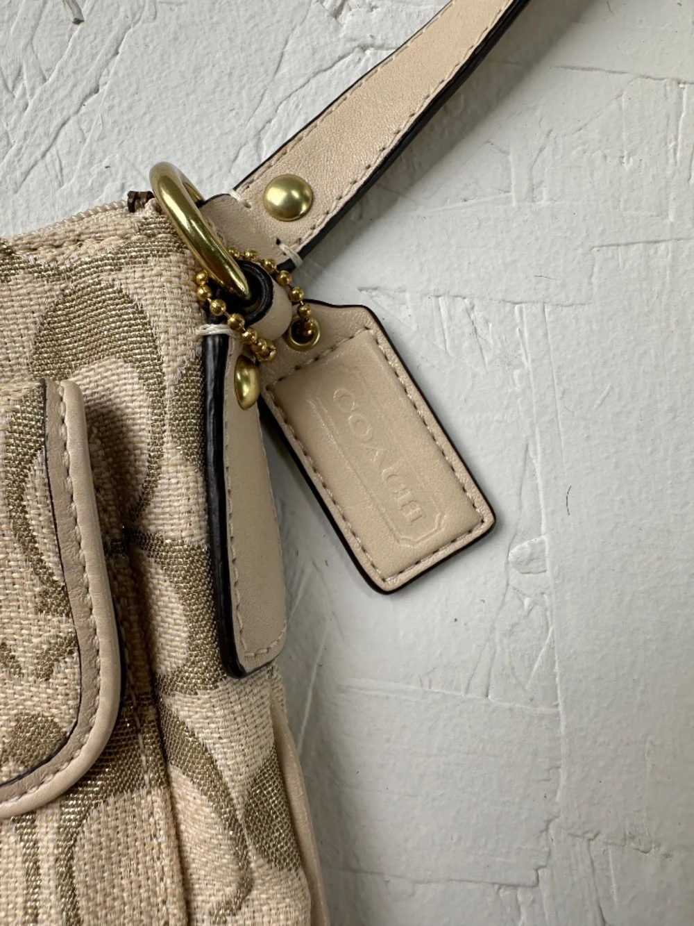 Coach Kristin Signature Crossbody Swing Bag in a metallic gold and beige fabric